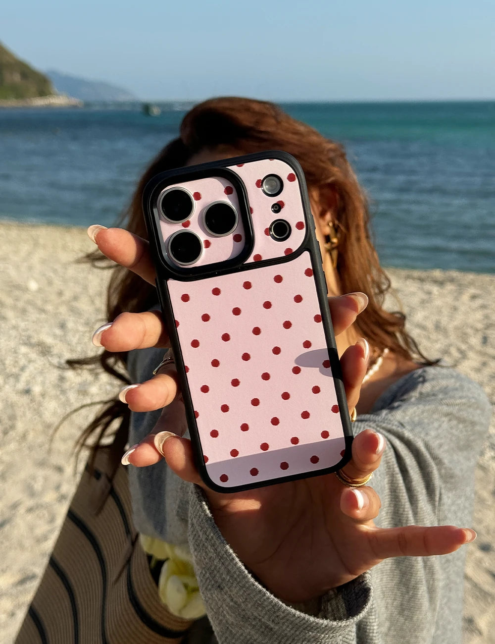The girl Holding Peachy Pink Polka Dot Phone Case - Tag-Switch System as a Fashion Statement.